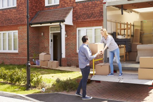 Professional furniture removal team handling a sofa