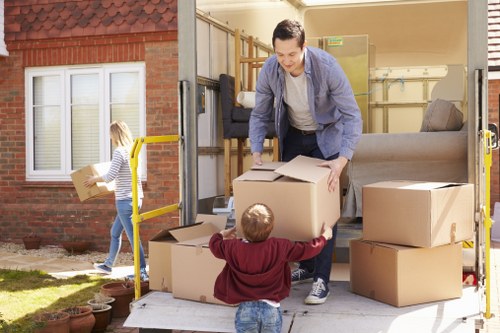 Professional movers preparing office equipment for a commercial move in London