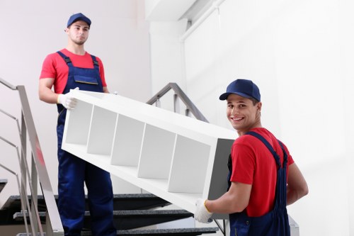 Professional movers handling office equipment